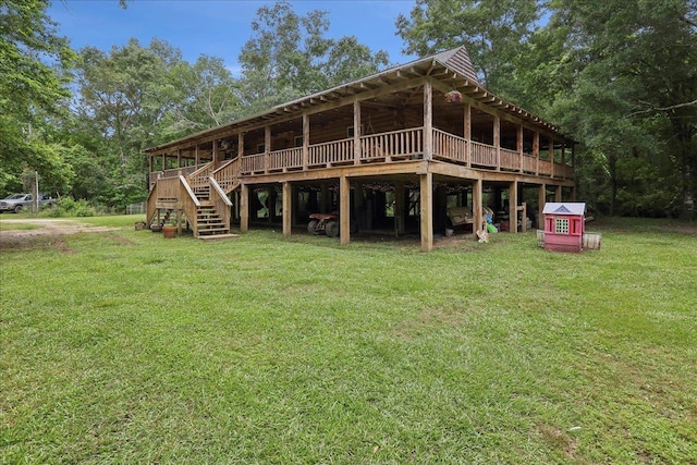 9570 Skeeter Dr, Orange, TX 77632 - rear view of house with a yard, stairway, and a wooden deck