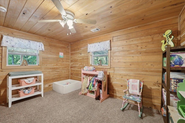 9570 Skeeter Dr, Orange, TX 77632 - rec room featuring plenty of natural light, wood ceiling, carpet flooring, a ceiling fan, and wood walls