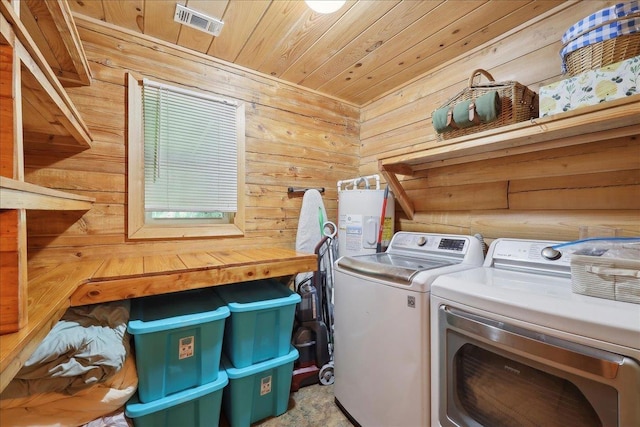 9570 Skeeter Dr, Orange, TX 77632 - washroom with washing machine and clothes dryer, wood walls, wooden ceiling, and water heater