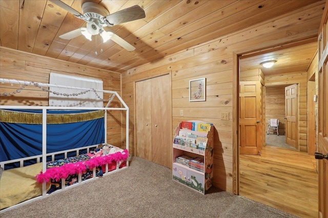9570 Skeeter Dr, Orange, TX 77632 - carpeted bedroom featuring wood ceiling, wood walls, and a closet