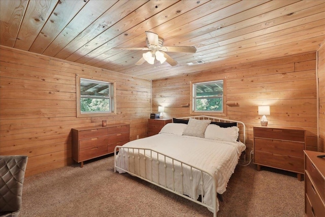 9570 Skeeter Dr, Orange, TX 77632 - bedroom featuring wood ceiling, multiple windows, light carpet, wooden walls, and a ceiling fan