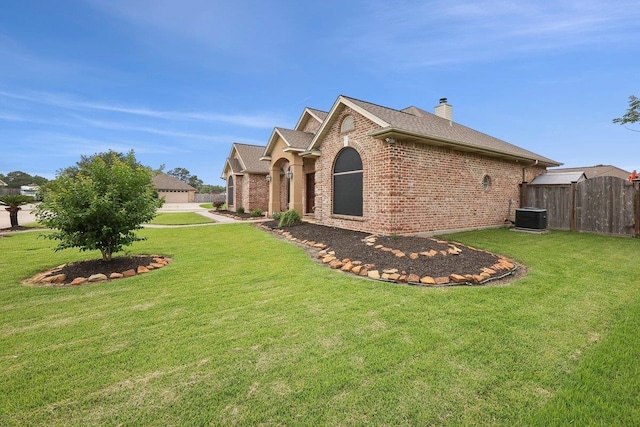 640 Winchester Dr, Bridge City, TX 77611 - view of home's exterior featuring brick siding, cooling unit, a chimney, and a shingled roof