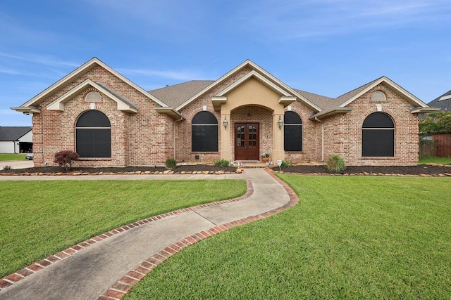 640 Winchester Dr, Bridge City, TX 77611 - single story home with brick siding, a front lawn, and roof with shingles