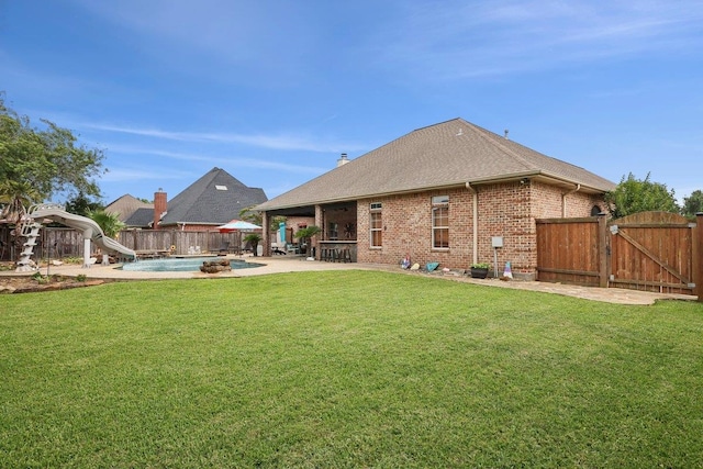 640 Winchester Dr, Bridge City, TX 77611 - rear view of house featuring a gate, a patio area, brick siding, and a shingled roof
