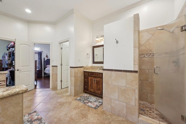 640 Winchester Dr, Bridge City, TX 77611 - ensuite bathroom featuring tile walls, a shower stall, ornamental molding, vanity, and a wainscoted wall