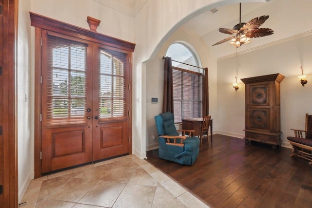 640 Winchester Dr, Bridge City, TX 77611 - foyer entrance with french doors, arched walkways, plenty of natural light, a ceiling fan, and crown molding