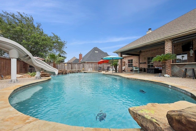 640 Winchester Dr, Bridge City, TX 77611 - view of pool with a water slide, a fenced backyard, and a patio area