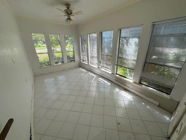 unfurnished sunroom featuring ceiling fan