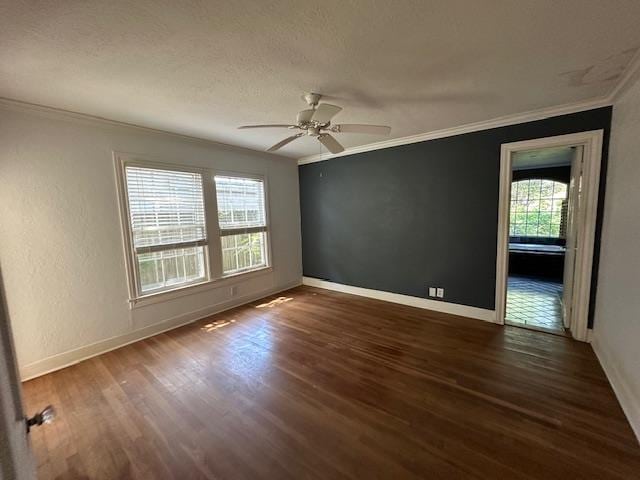 spare room featuring a textured ceiling, dark hardwood / wood-style floors, ceiling fan, and ornamental molding