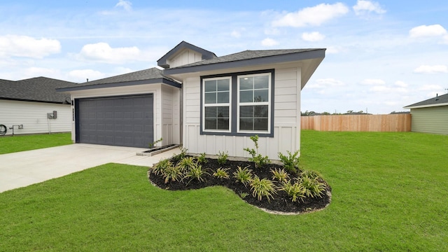 view of front of house with a front lawn and a garage