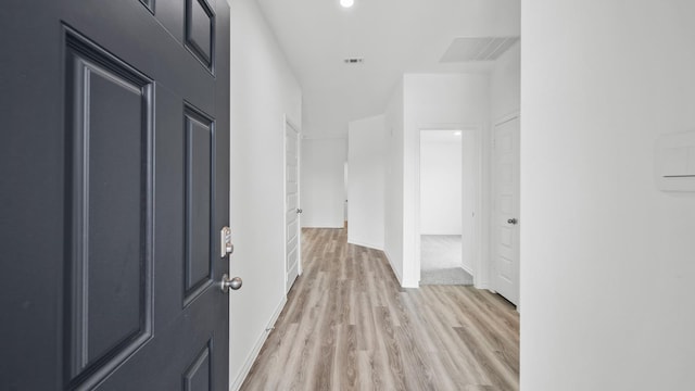 hall with light hardwood / wood-style flooring