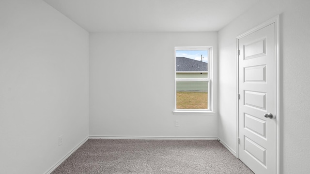 unfurnished room with carpet flooring and plenty of natural light