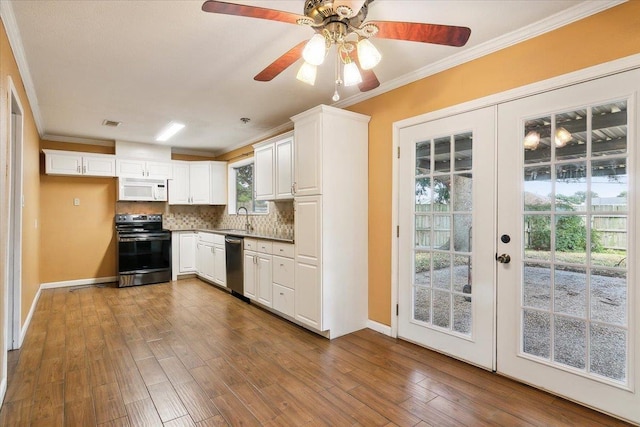 kitchen featuring french doors, white cabinets, and appliances with stainless steel finishes