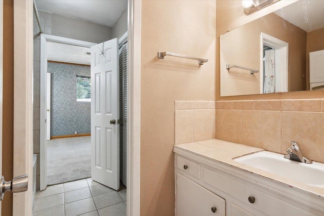 bathroom featuring decorative backsplash, vanity, and tile patterned floors