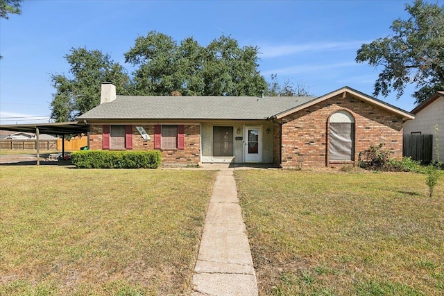 single story home featuring a carport and a front lawn