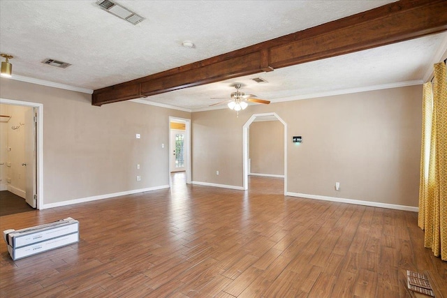 spare room featuring beamed ceiling, a textured ceiling, and hardwood / wood-style flooring