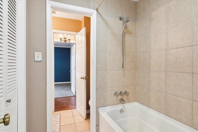 bathroom with tile patterned floors and tiled shower / bath