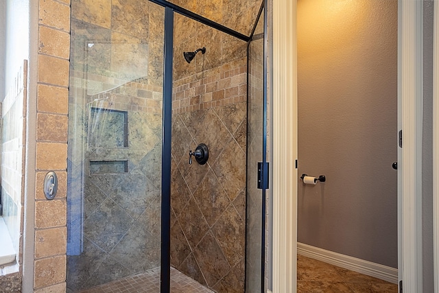 bathroom featuring a shower with shower door