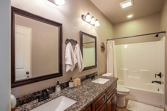 full bathroom with vanity, shower / bath combo, and toilet