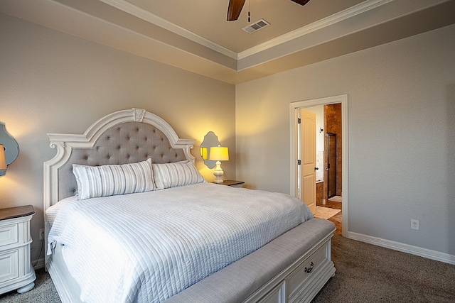 bedroom featuring a tray ceiling, ceiling fan, dark carpet, and ornamental molding