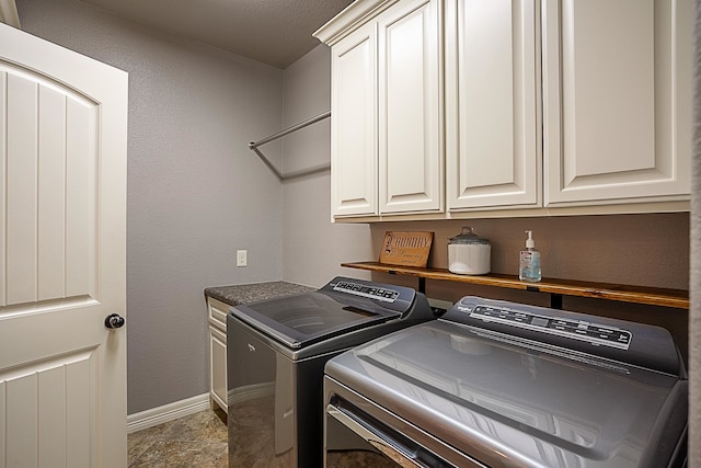 laundry area featuring cabinets and separate washer and dryer