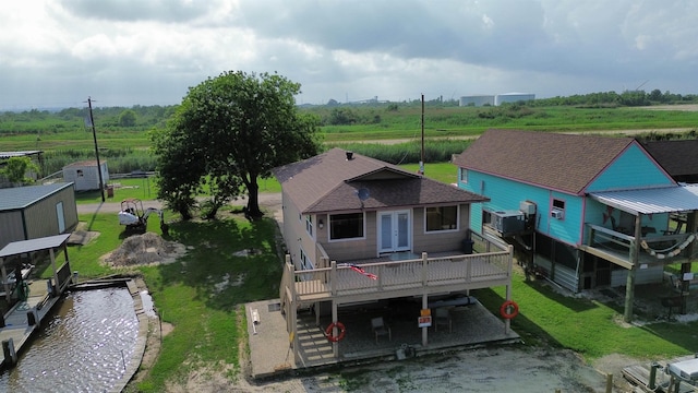 rear view of property featuring french doors and a wooden deck