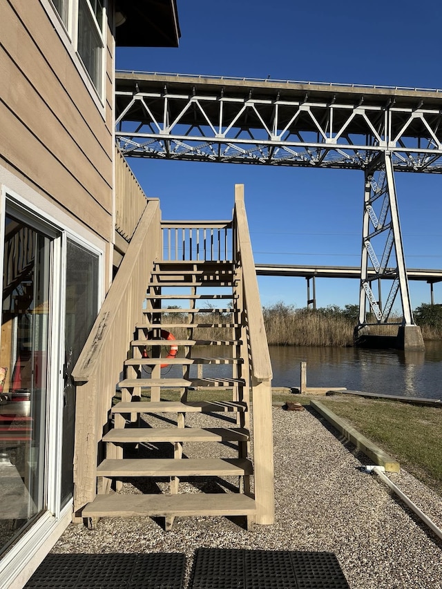 exterior space with a water view and stairway