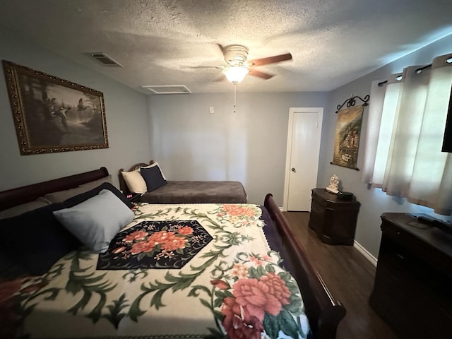 bedroom with a ceiling fan, visible vents, a textured ceiling, and wood finished floors