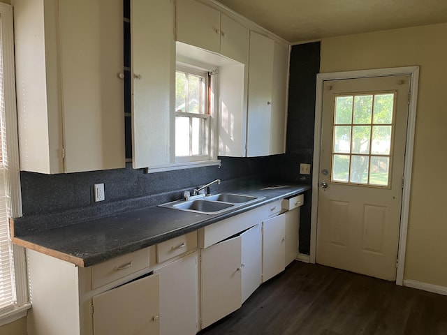 5345 E Parkway Dr, Beaumont, TX 77705 - kitchen featuring dark countertops, a sink, dark wood finished floors, and a wealth of natural light