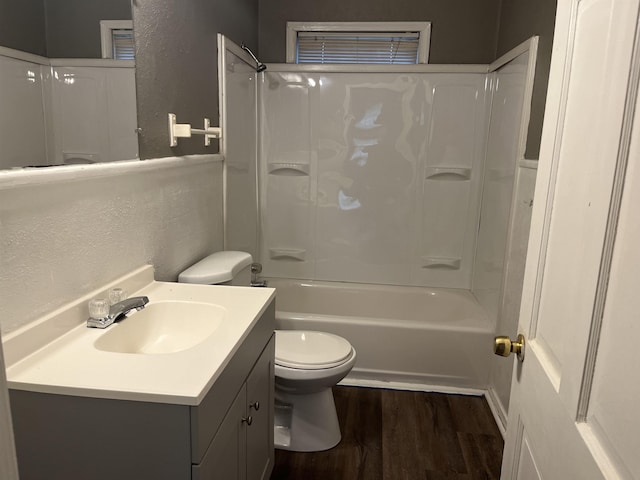 5345 E Parkway Dr, Beaumont, TX 77705 - full bath featuring toilet, a textured wall, vanity, wood finished floors, and bathing tub / shower combination