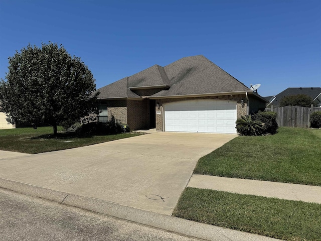 view of front of house featuring a garage and a front yard