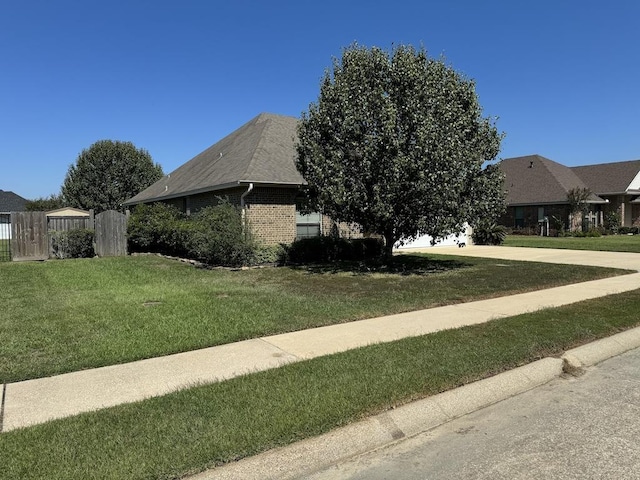 view of side of property featuring a lawn