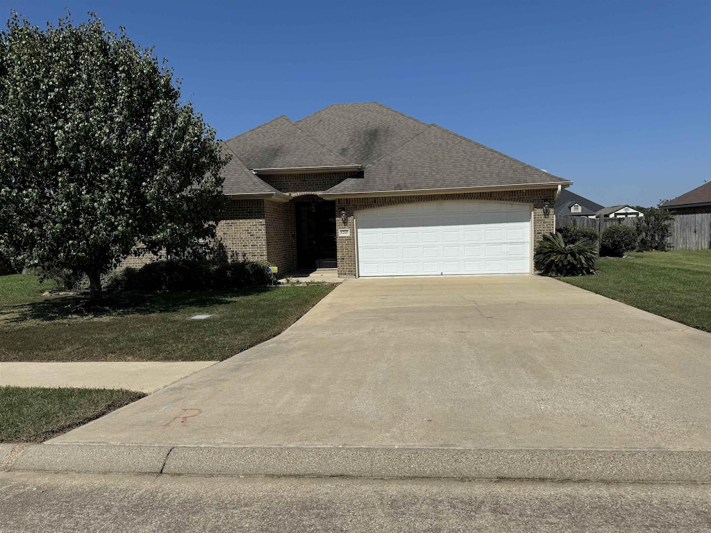 view of front facade with a garage and a front lawn