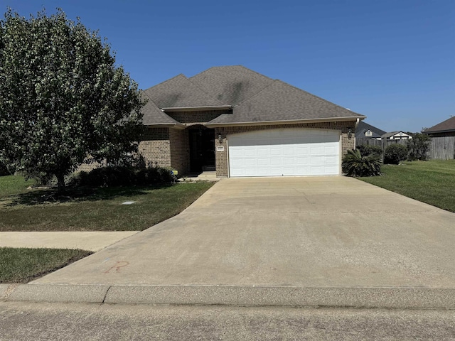 view of front facade with a garage and a front lawn