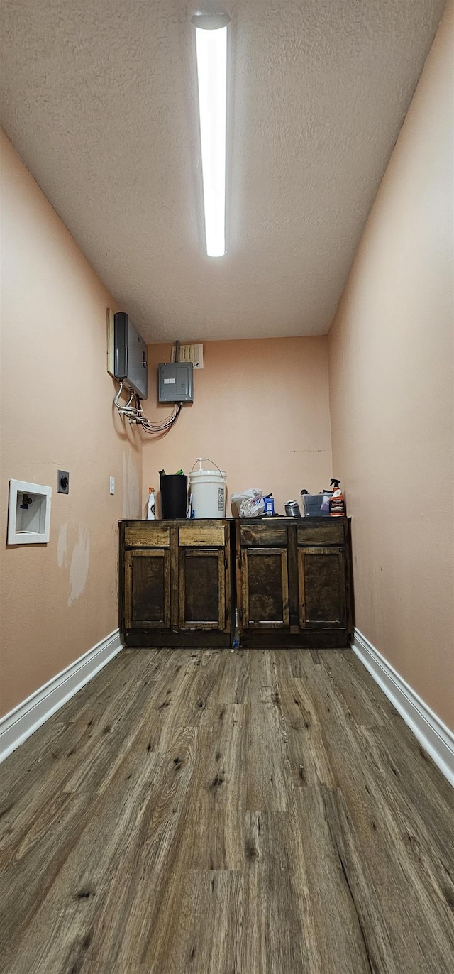 interior space featuring wood-type flooring and a textured ceiling