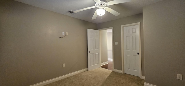 unfurnished bedroom featuring carpet flooring and ceiling fan