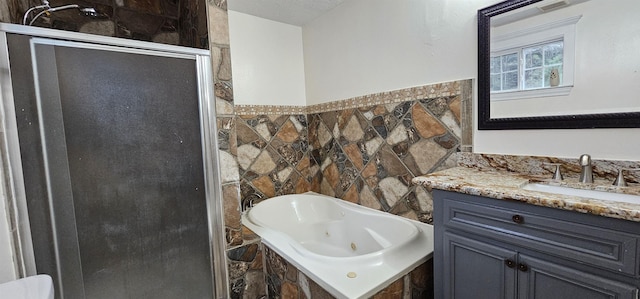 bathroom with vanity and independent shower and bath