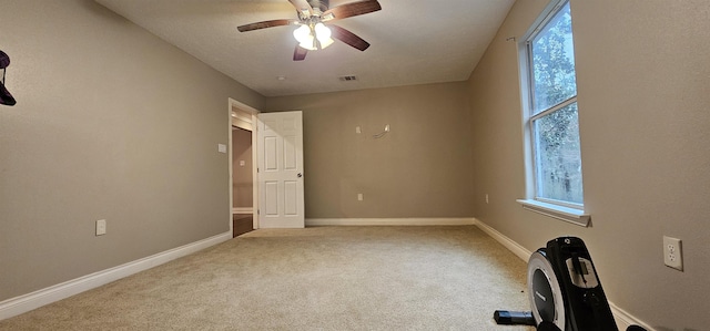 carpeted empty room with ceiling fan