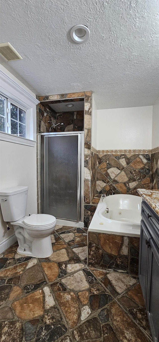 full bathroom with plus walk in shower, vanity, a textured ceiling, and toilet