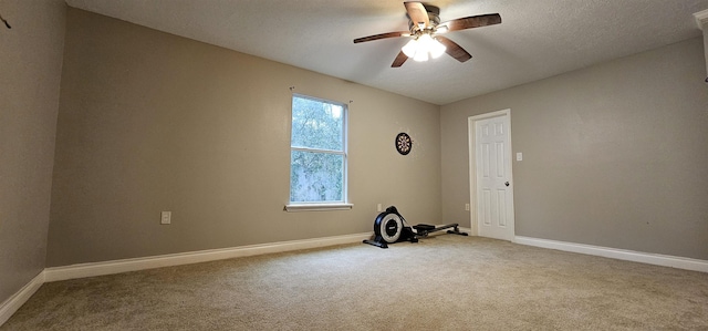 spare room with carpet, a textured ceiling, and ceiling fan