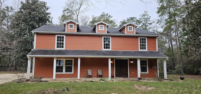 view of front of home featuring covered porch and a front yard