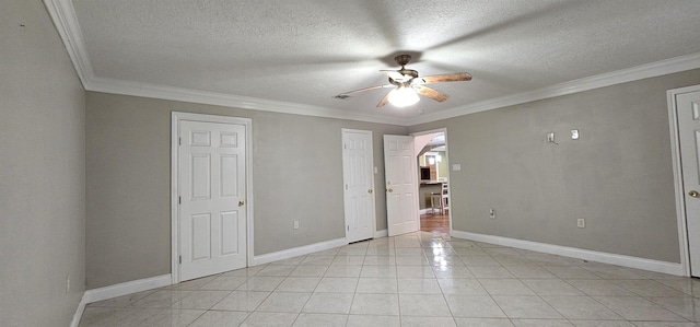 interior space featuring ceiling fan, light tile patterned floors, a textured ceiling, and ornamental molding