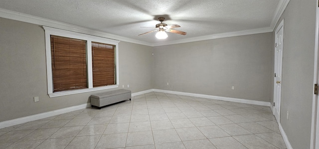 empty room with ceiling fan, light tile patterned floors, a textured ceiling, and ornamental molding