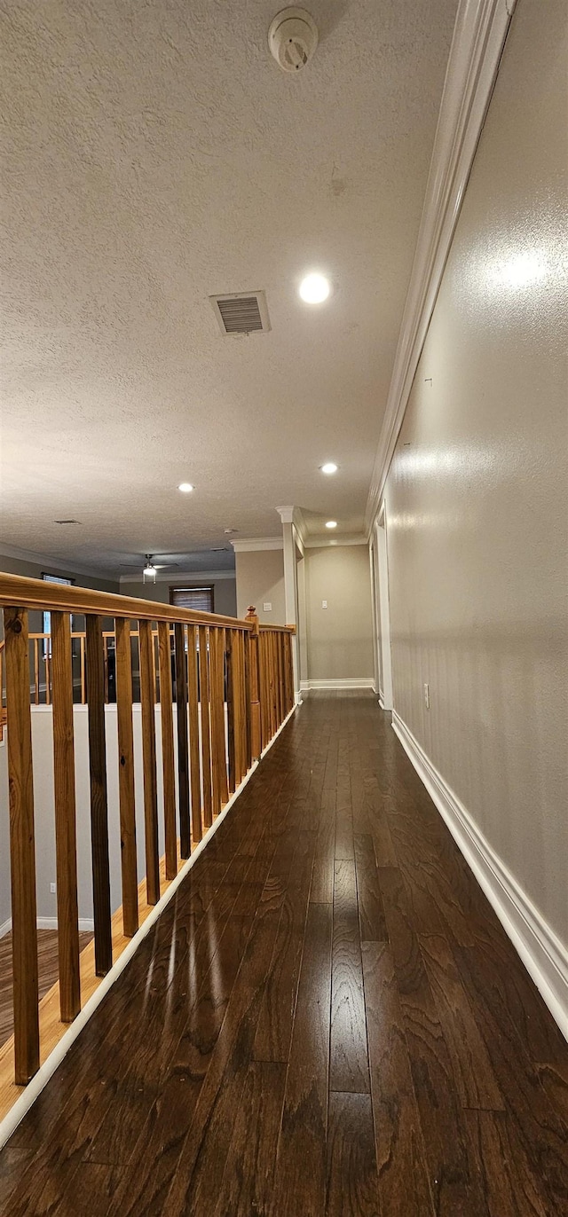 hall featuring crown molding and dark hardwood / wood-style flooring