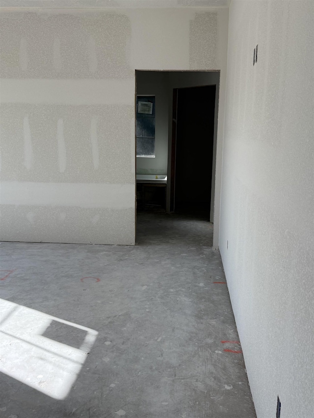 unfurnished room featuring concrete flooring