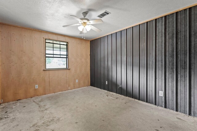 400 French Rd, Lumberton, TX 77657 - spare room featuring ceiling fan, wood walls, and a textured ceiling