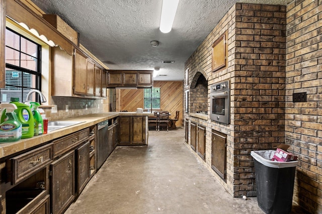 400 French Rd, Lumberton, TX 77657 - kitchen with unfinished concrete floors, appliances with stainless steel finishes, healthy amount of natural light, a textured ceiling, and light countertops