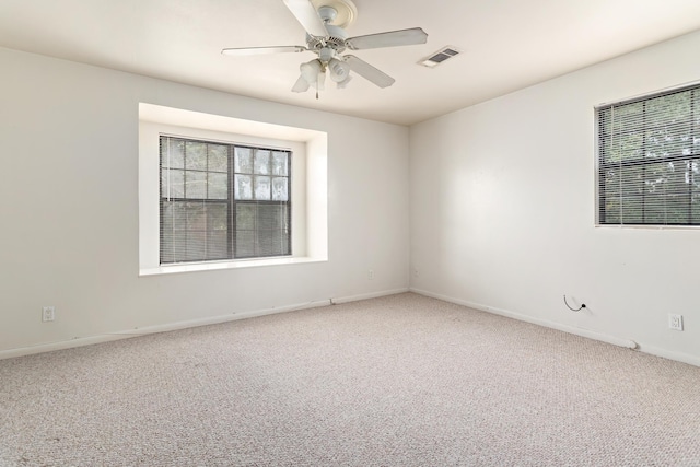 spare room featuring carpet flooring and ceiling fan