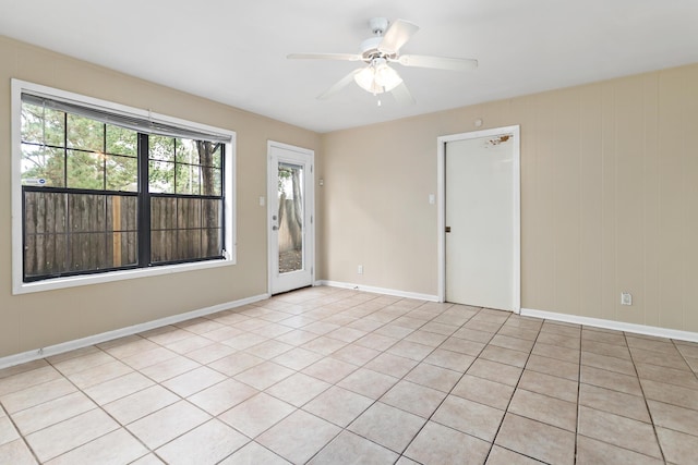 tiled empty room with ceiling fan