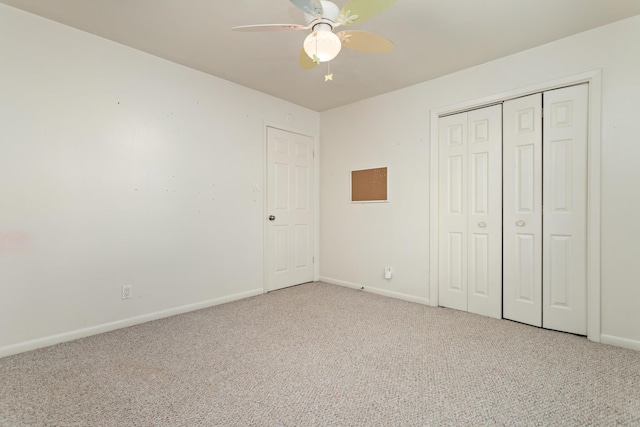 unfurnished bedroom with carpet, ceiling fan, and a closet